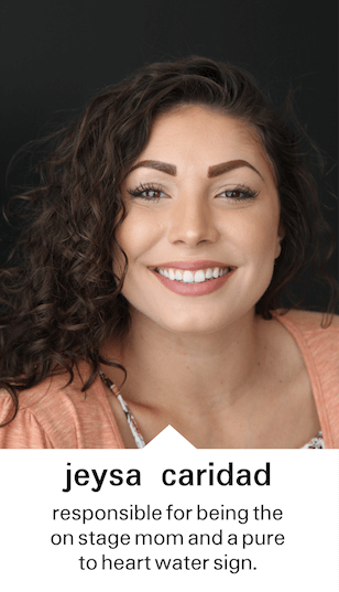 Jeysa Caridad smiling for a photo by a black door with a quote that says "responsible for being the on stage mom and a pure to heart water sign" below the photo, at the Crane Creations Theatre Company studio, a professional theatre company
