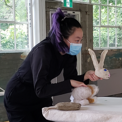 Mya puppeteering a rabbit for Cranes showcase of Mirror (a puppet show)live events in Mississauga and activities in Mississauga